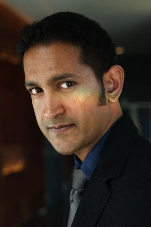 Professional headshot of male industry executive in business attire